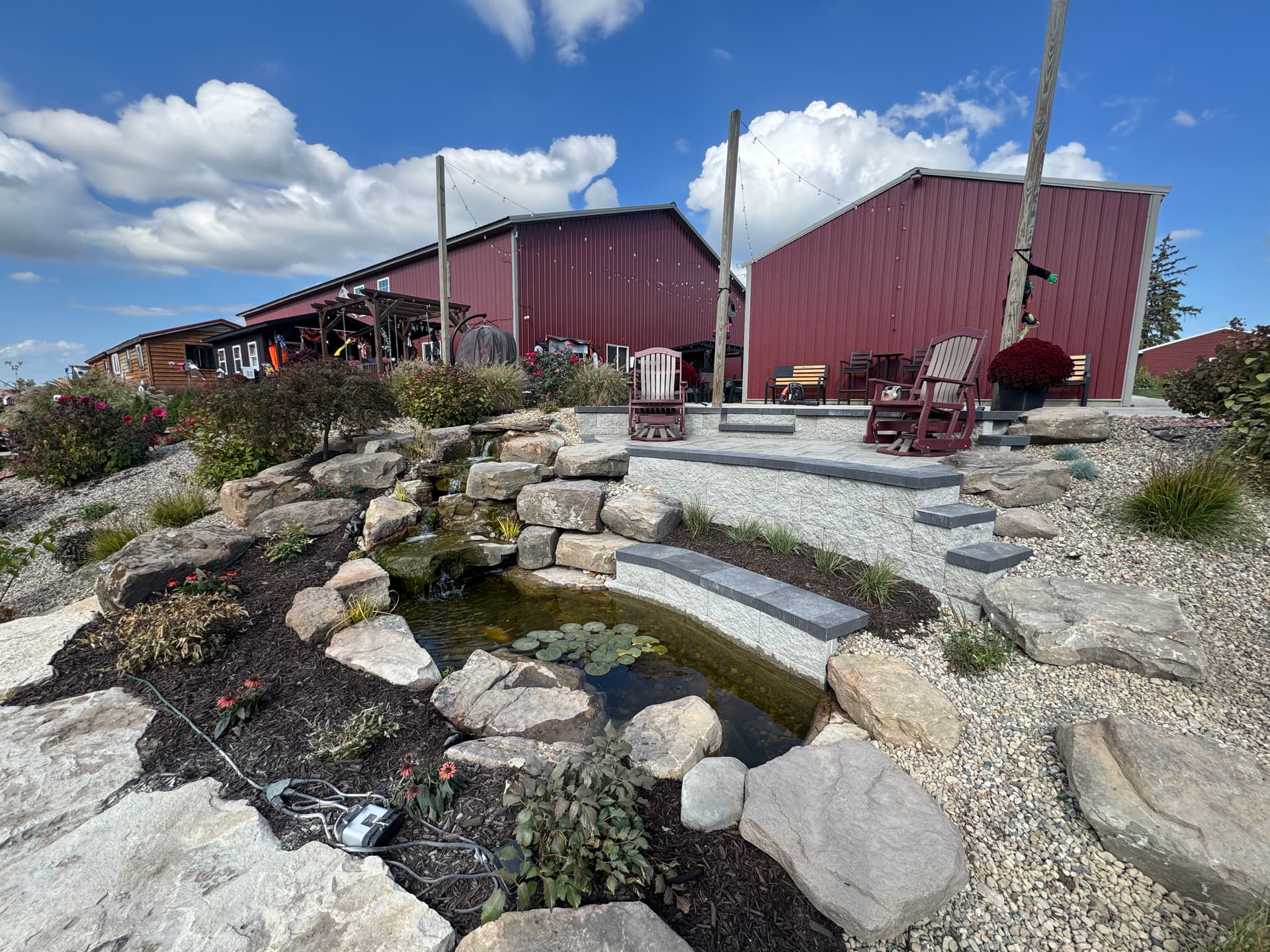 Hillside Turned Backyard Retreat With Koi Pond and Paver Patio