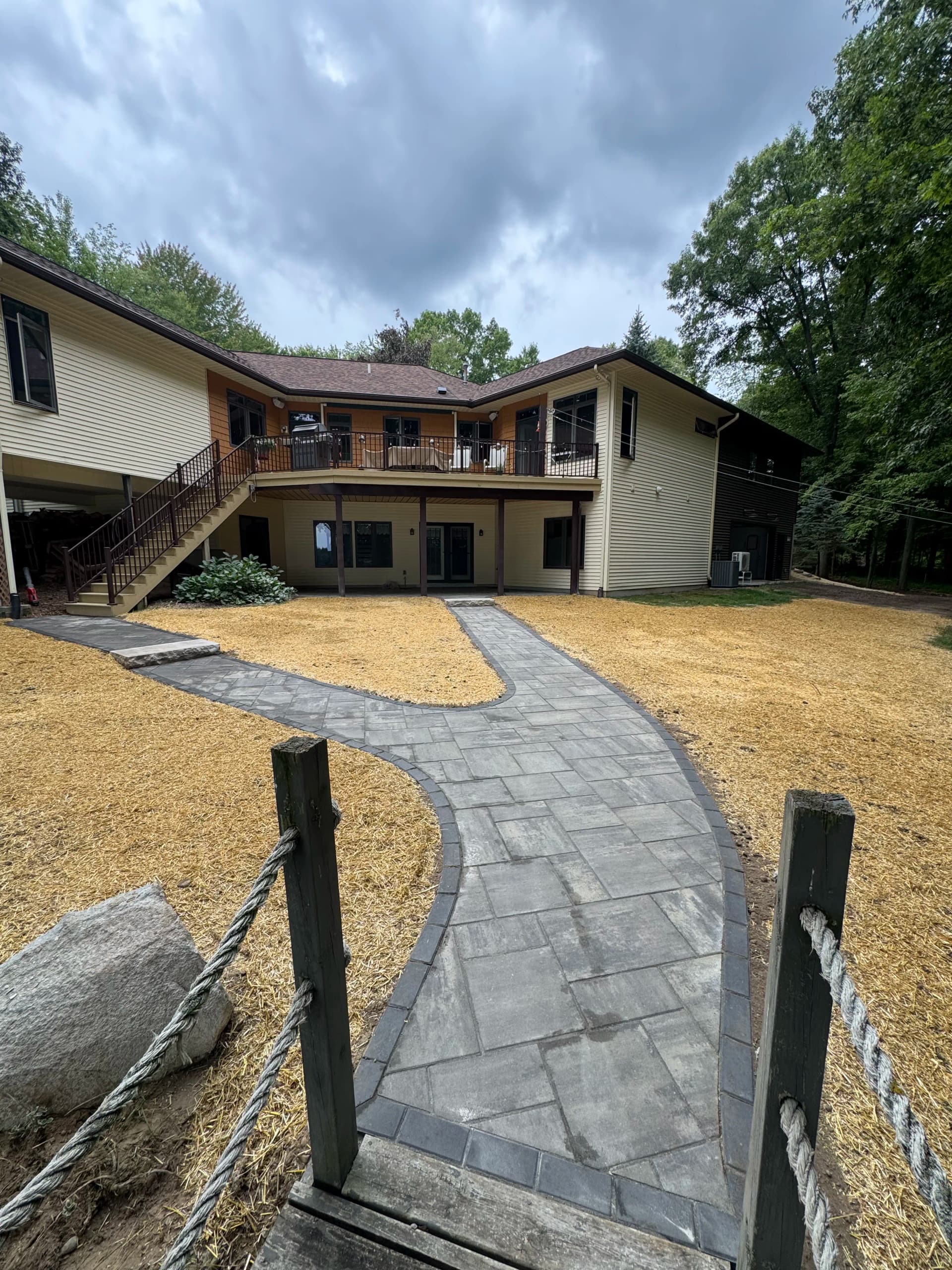 760 Sq Ft Paver Patio and Walkway Built on a Sloped Lakefront Yard image